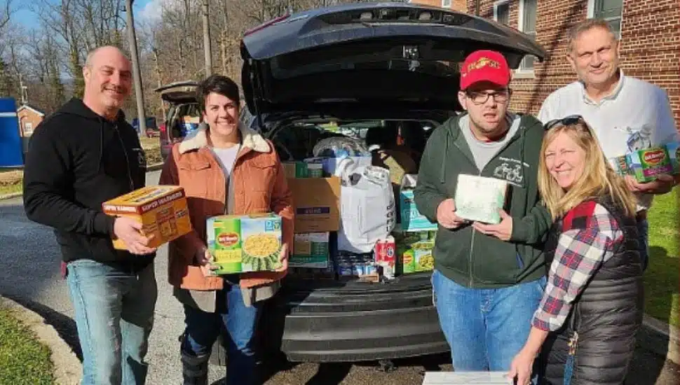 Music teacher Anthony Cracchiolo and several donation campaign members with a car full of donated items.