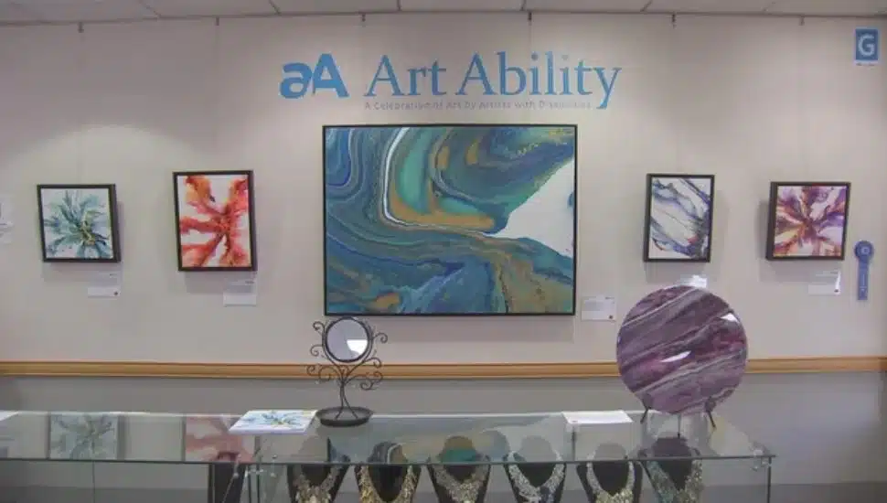 Art pieces and a title sign at Bryn Mawr Rehab Hospital's Art Ability exhibition.
