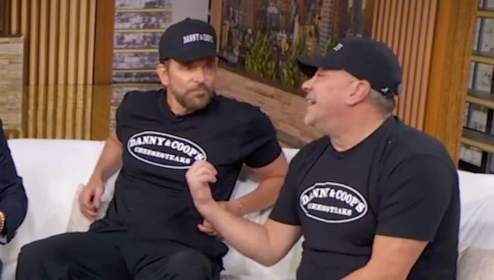 Bradley Cooper talking to another guy.