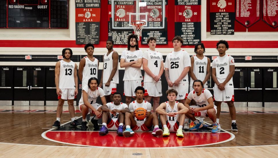 Coatesville Boys Basketball team photo in the gym.
