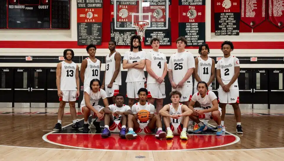 Coatesville Boys Basketball team photo in the gym.