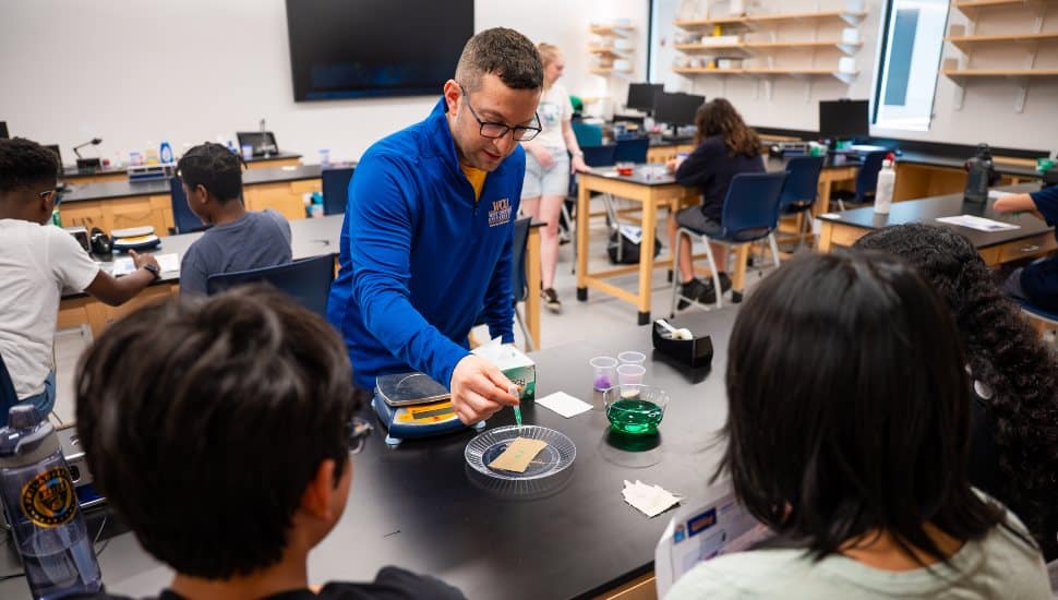 Dr. Brandon Mitchell, Professor of Physics and Engineering who helped establish and currently leads West Chester University’s Center for STEM Inclusion, is pictured working with high school students in a recent workshop held on campus to introduce the youth to career fields in science, technology, engineering, and mathematics.