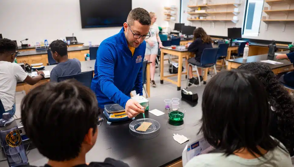 Dr. Brandon Mitchell, Professor of Physics and Engineering who helped establish and currently leads West Chester University’s Center for STEM Inclusion, is pictured working with high school students in a recent workshop held on campus to introduce the youth to career fields in science, technology, engineering, and mathematics.