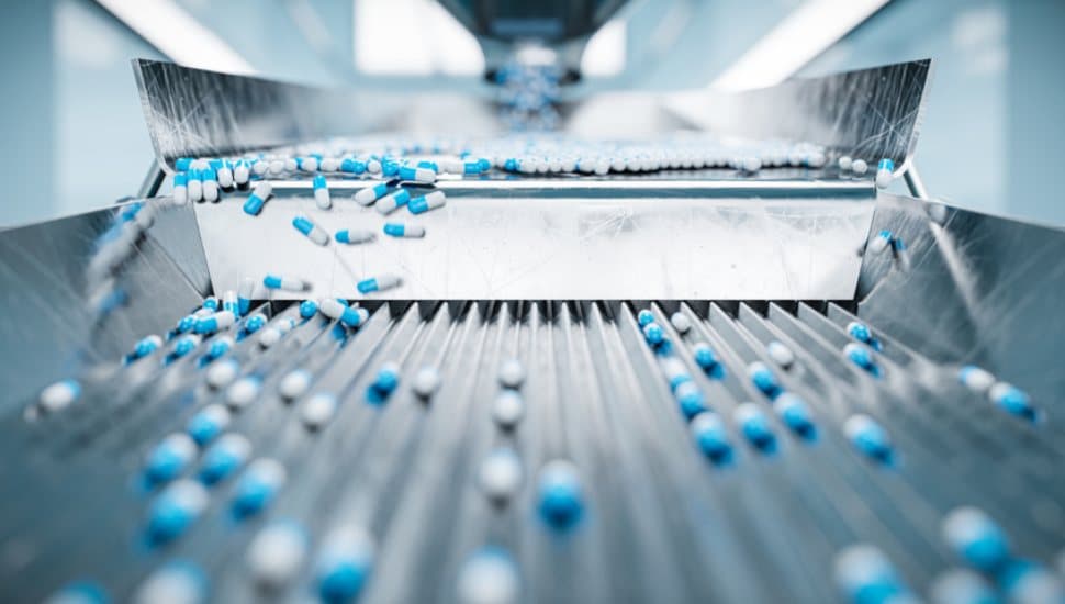 Pills coming out of a machine.