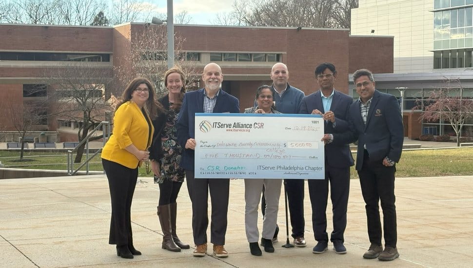 Group of ITServe Alliance and Delaware County Community College representatives holding a $5,000 scholarship donation check on campus.
