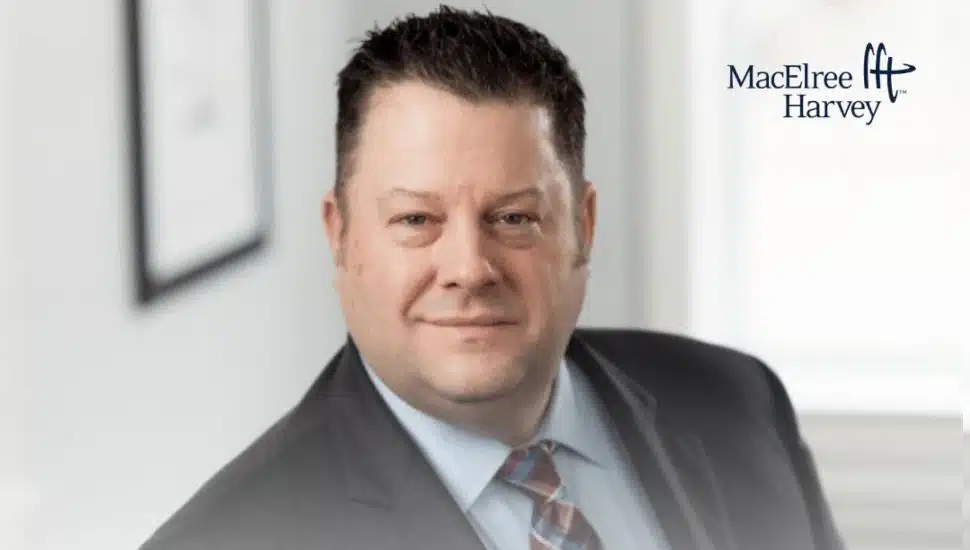 Photo of Judge Lou Mincarelli smiling at a MacElree Harvey office event announcing his return to the firm’s Litigation Department.