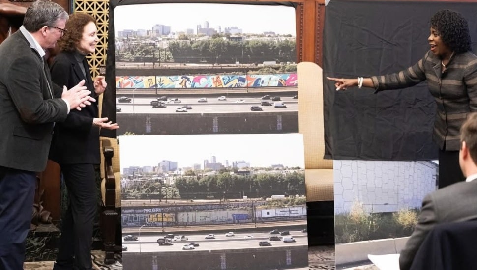 Mayor Parker looks at rendering image.