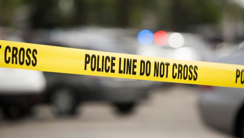 Police tape in focus with blurry background.