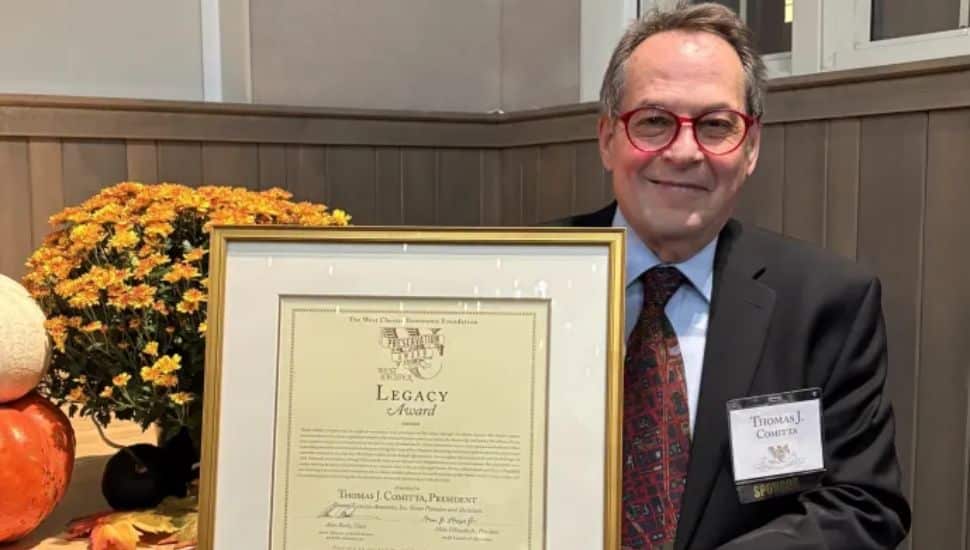 Tom Comitta holding preservation award.