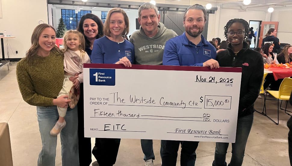 Group of community members holding a large ceremonial check from First Resource Bank for $15,000 made out to the Westside Community Center, supporting education through the Pennsylvania EITC program.