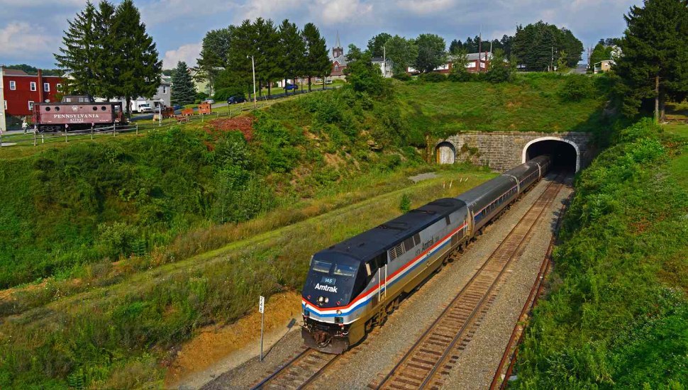 Amtrak's "Pennsylvanian" train traveling along Pennsylvania countryside.