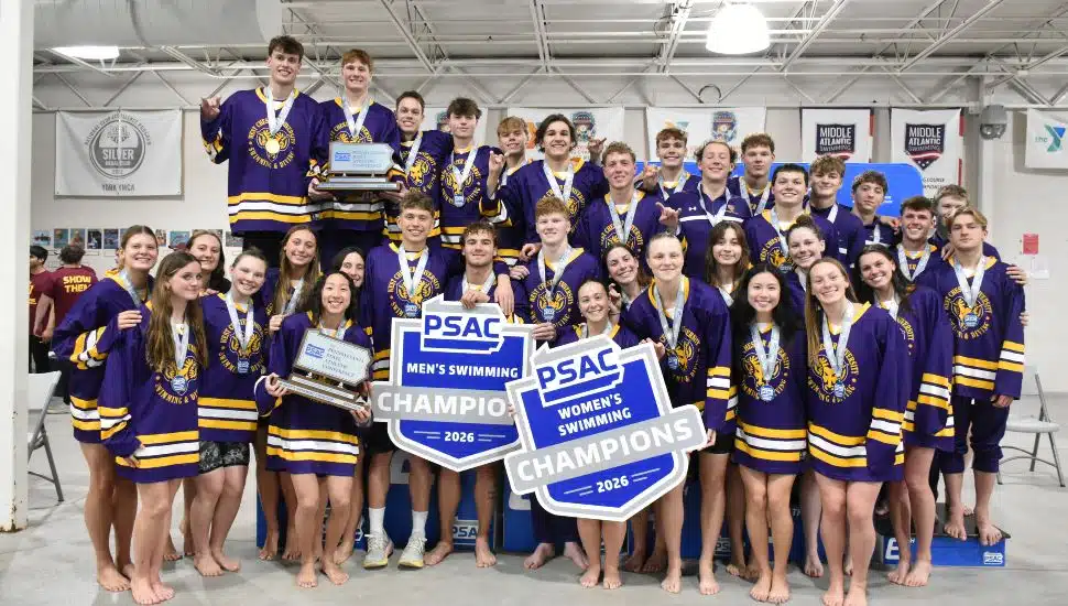 West Chester University men’s and women’s swimming teams celebrate 2026 PSAC Championships with trophies and champion signs at York YMCA Graham Pool.