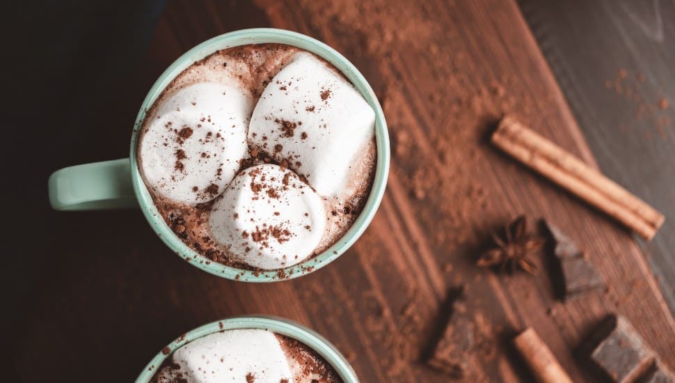 A mug of hot chocolate topped with marshmallows.