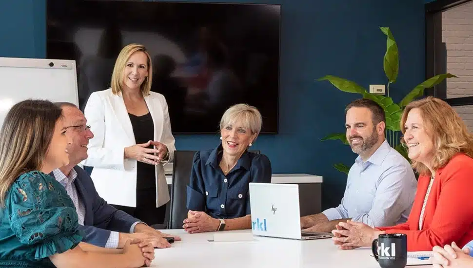 Accounting professionals work in conference room.