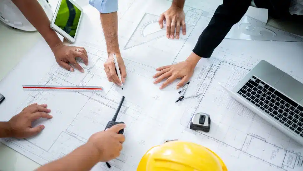 Group of engineers discussing plans.