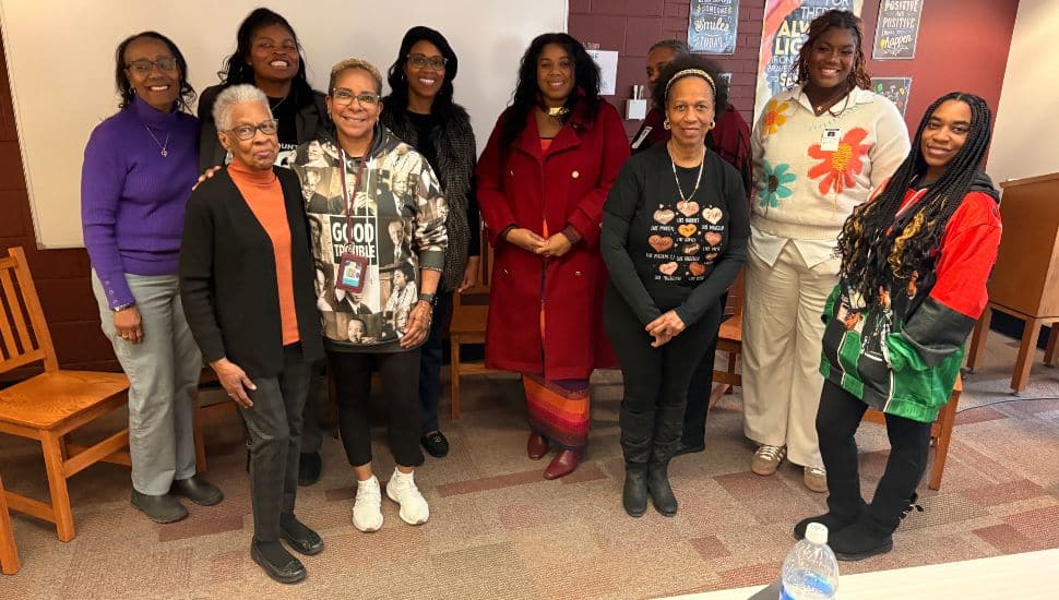 Group photo of women panelists and organizers from the February 17 Black History Month discussion at Henderson High School, standing together and smiling in a classroom setting.