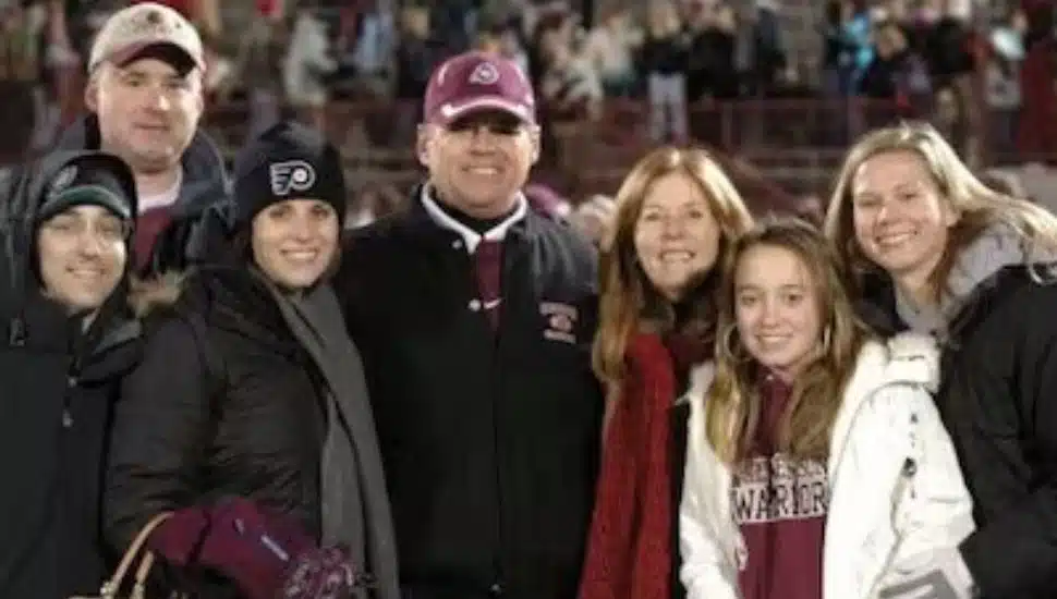 Joe Walsh, center, with his family on football field.