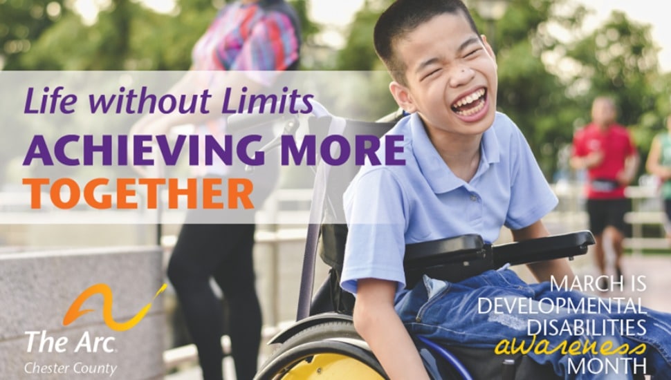 A laughing boy in a wheelchair.
