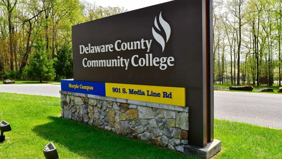Delaware County Community College campus sign on sunny day.