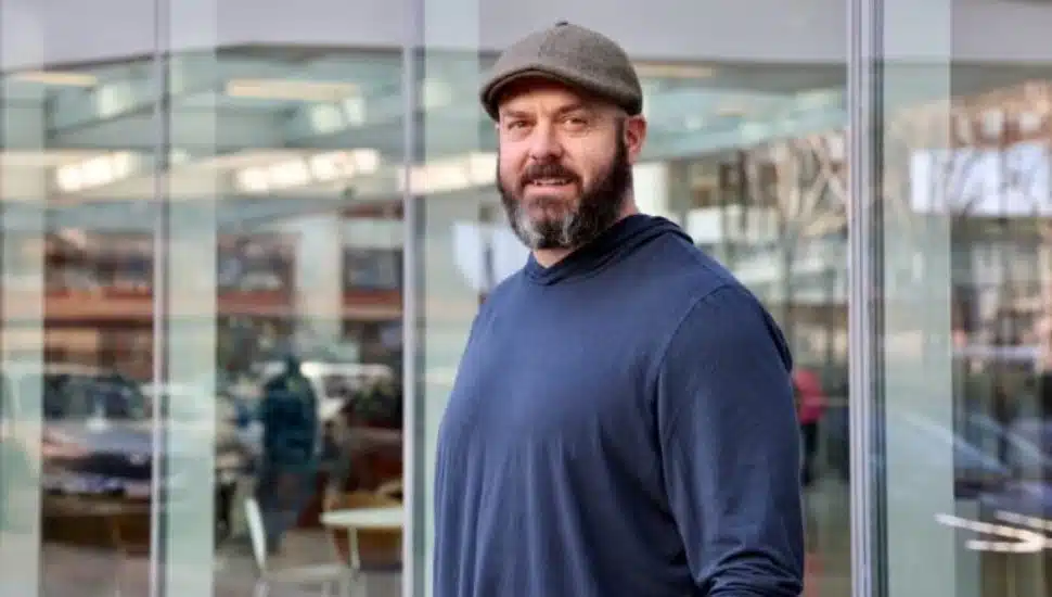 Dennis Massimo wearing a hat with windows in background.