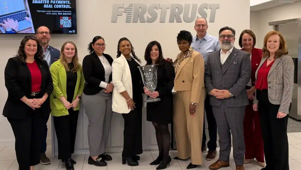 Bank employees pose for group photo.