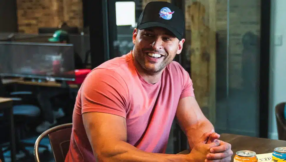 Ryan Hughes, Ghost brand founder wearing hat and pink shirt.