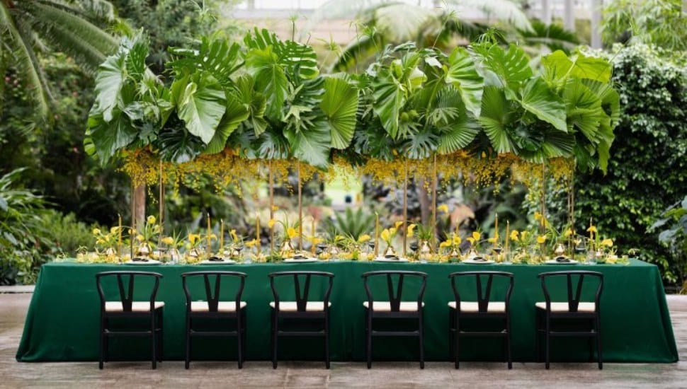 An event table and surrounding chairs at a Longwood Gardens event in the Main Conservatory.