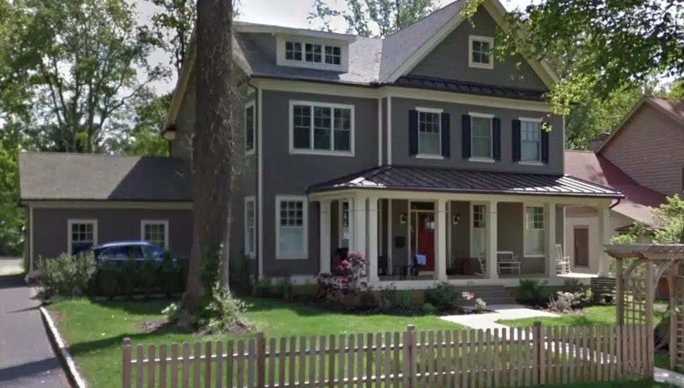 Exterior view of single-family home with tree in front yard.