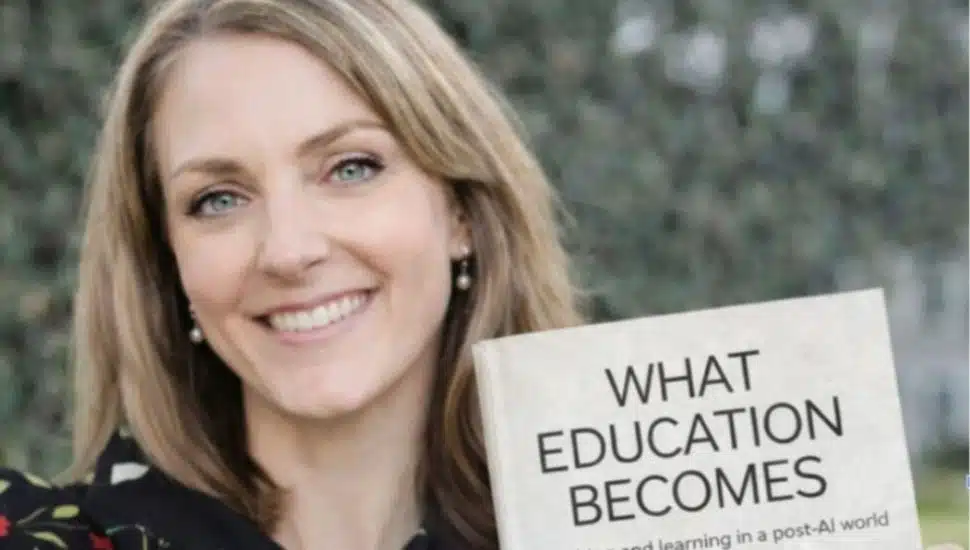 DCCC professor Susan Ray holding book.