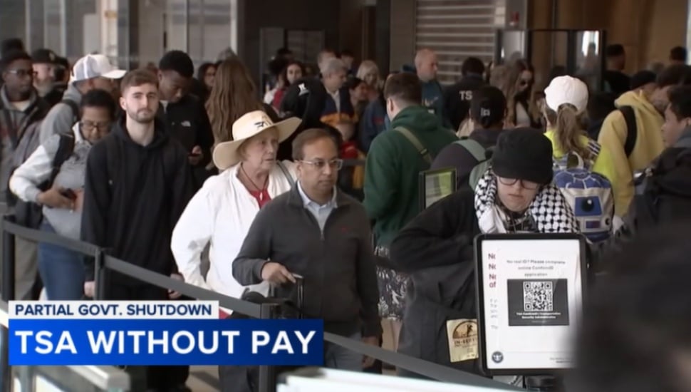 Passengers wait in line at a TSA security checkpoint at Philadelphia International Airport.