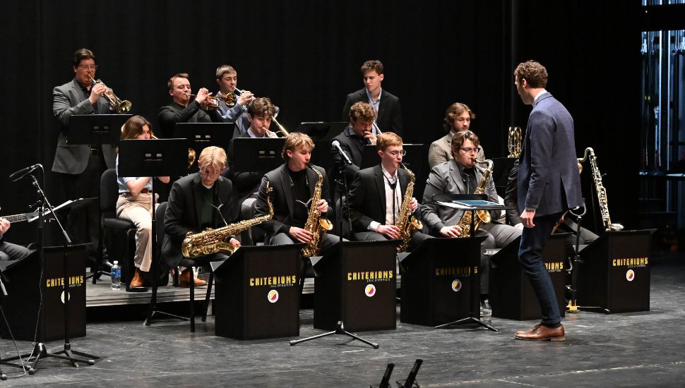 West Chester University’s Criterions Jazz Ensemble performing on stage with a conductor during the annual WCU Jazz Festival.