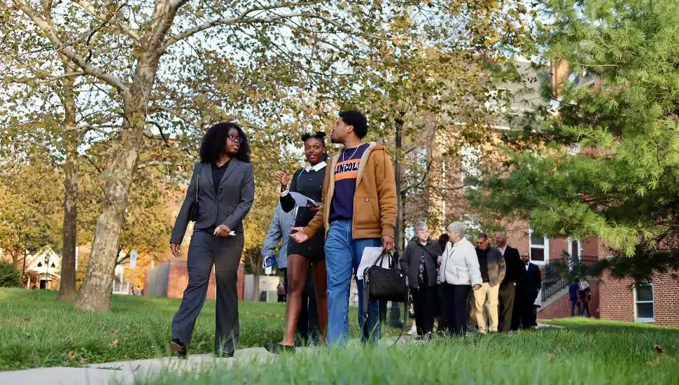 Lincoln students walking on campus sidewalk.