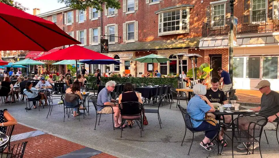 Outdoor dining with people eating at tables on Gay Street in West Chester.