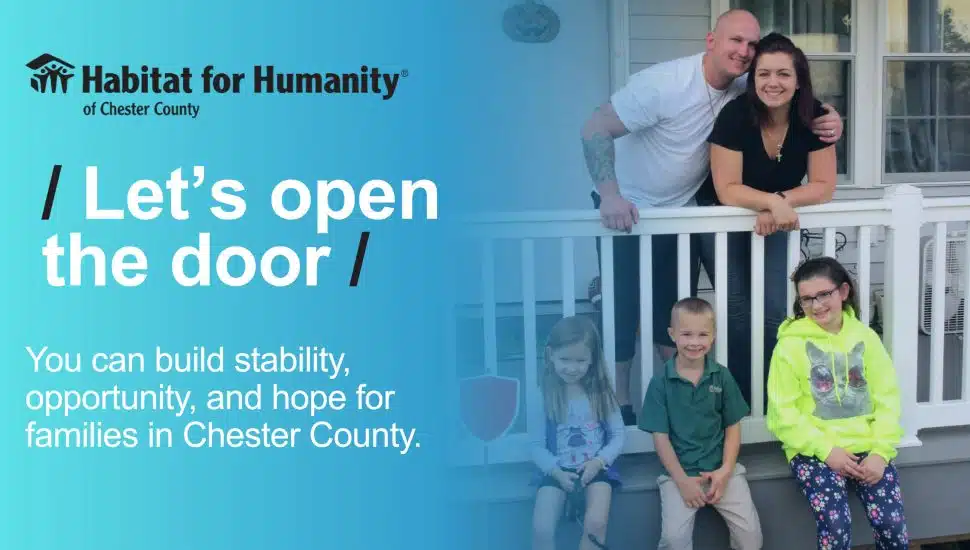 Family standing on the porch of their new home supported by Habitat for Humanity of Chester County, representing affordable housing and community stability.