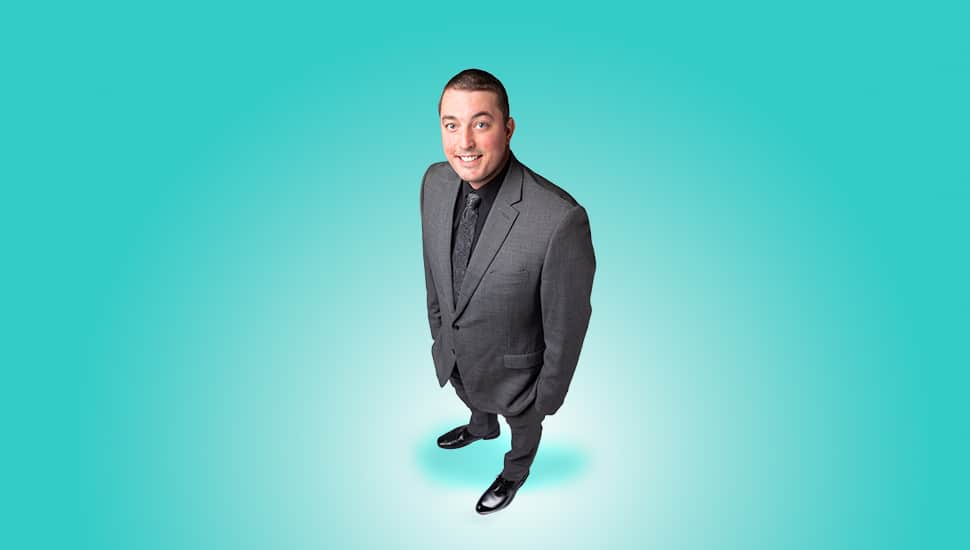 Young male nonprofit leader in suit.