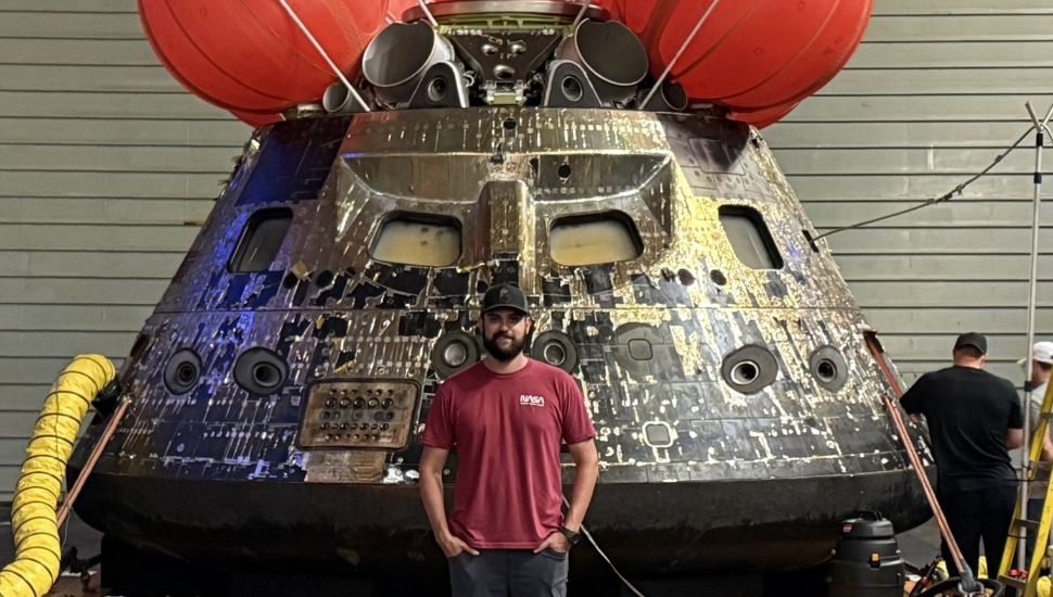 NASA engineer and Downingtown STEM Academy alum Cameron O'Rourke in front of the Orion spacecraft, Integrity.