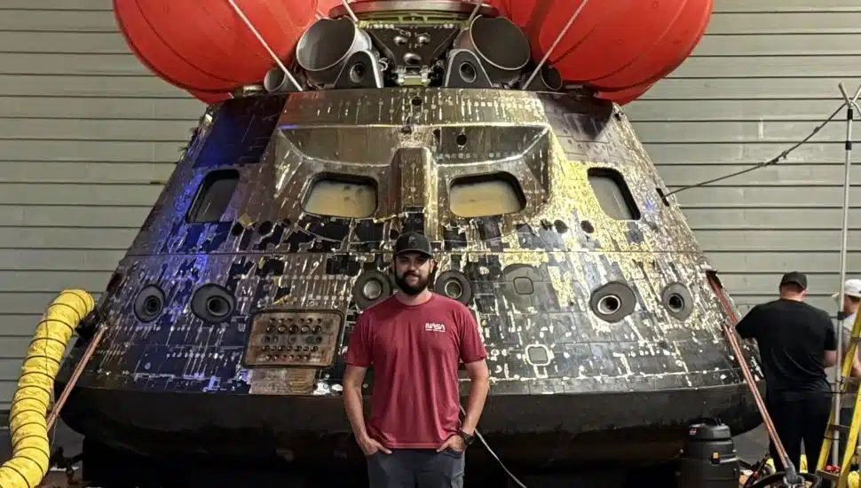 NASA engineer and Downingtown STEM Academy alum Cameron O'Rourke in front of the Orion spacecraft, Integrity.