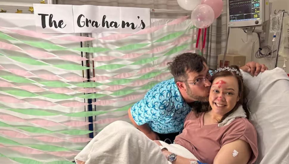 Derek Graham and Melissa Kellogg pose for a hospital bed wedding photo at Lankenau's emergency room.