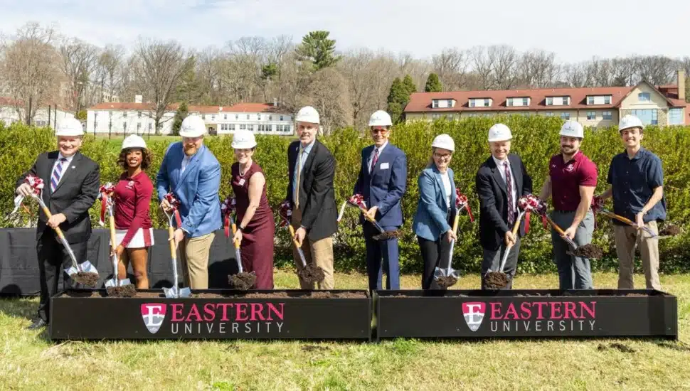 College officials hold shovels at groundbreaking ceremony.