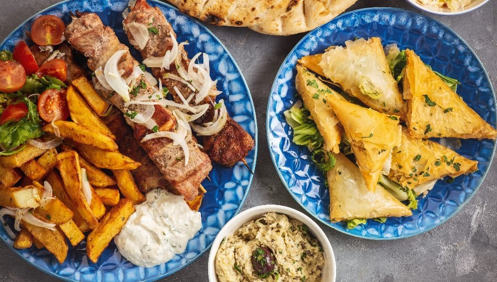 Several plates of traditional Greek food.
