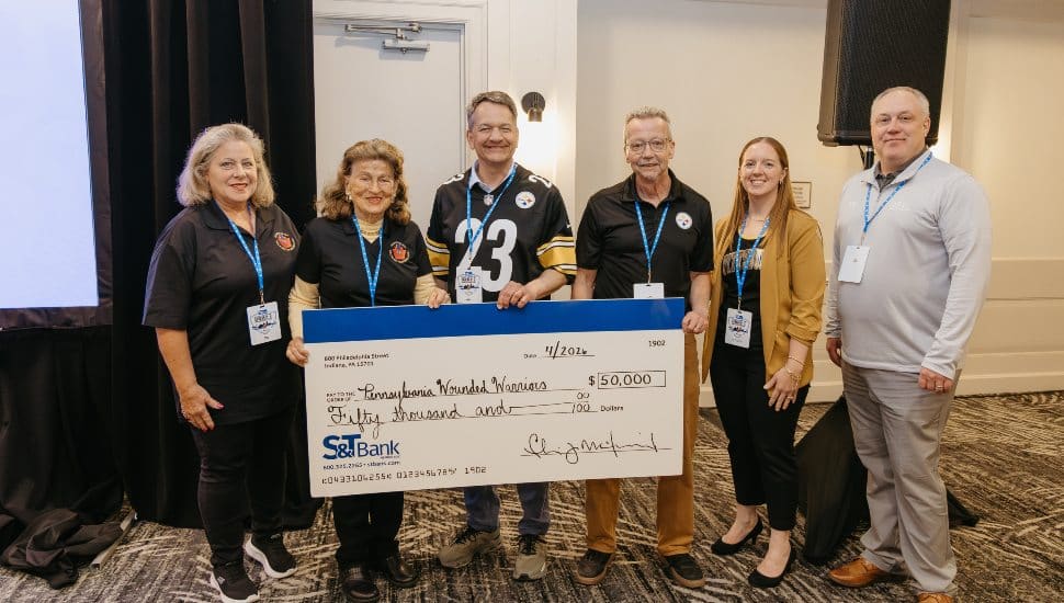 Group standing with check.