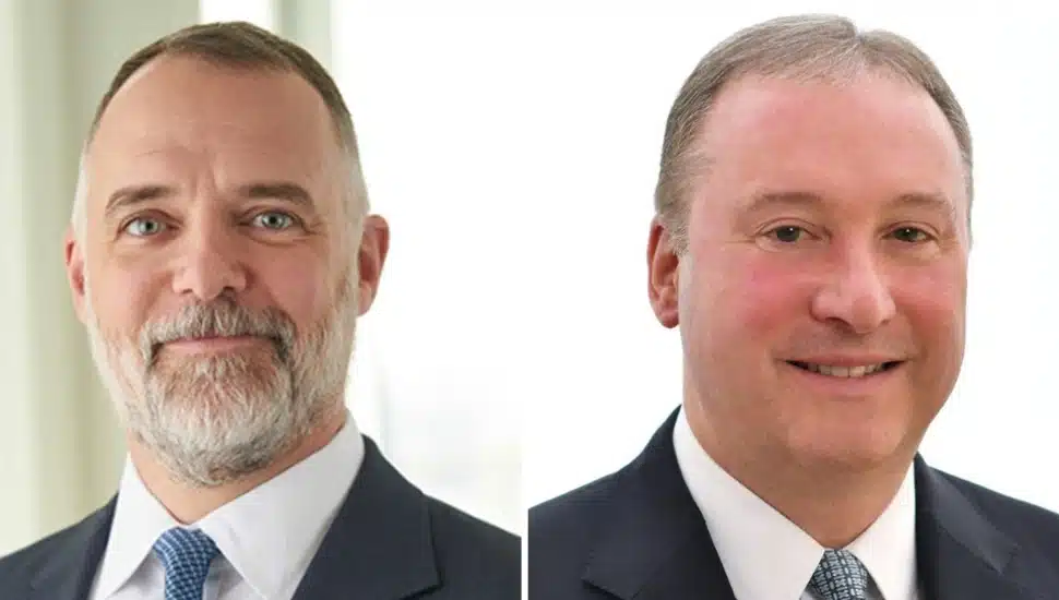 Headshots to two middle-aged male executives at utility company.