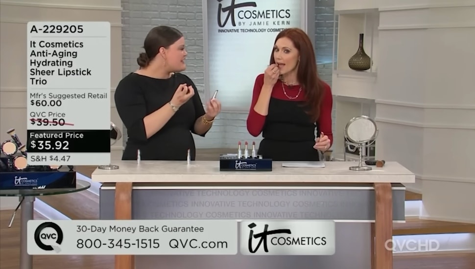 A QVC host demonstrates an It Cosmetics product.