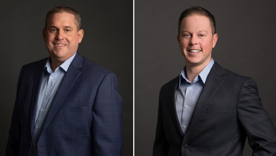 Headshots of two male business executives in dark suits and open-collared shirts.