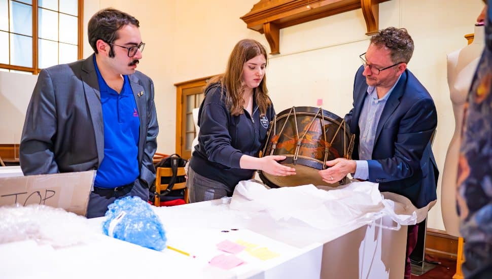 (L to R) Pictured are Roman Straub, Violet Curran, and Dr. Michael A. Di Giovine as they examine the Civil War Infantry Regulation Field Drum from the Hartenberger World Music Collection in St. Louis, Missouri.
