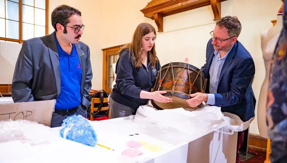 (L to R) Pictured are Roman Straub, Violet Curran, and Dr. Michael A. Di Giovine as they examine the Civil War Infantry Regulation Field Drum from the Hartenberger World Music Collection in St. Louis, Missouri.