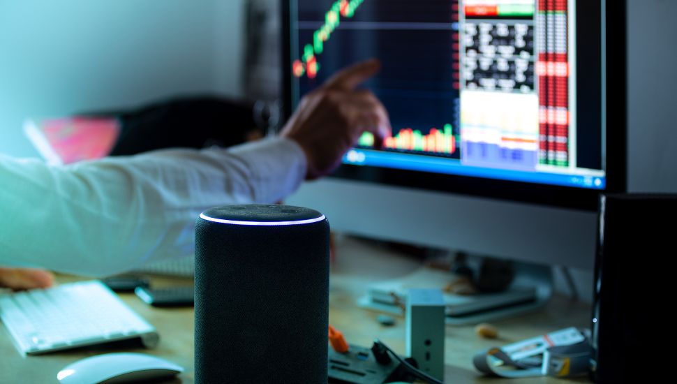 Amazon Alexa speaker on person's desk.