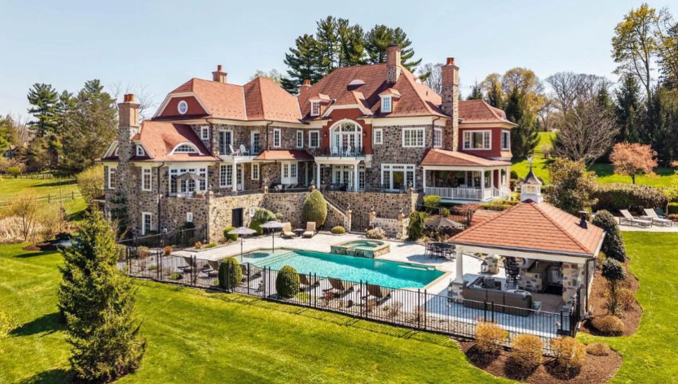 Stone-Clad Berwyn Estate with Fireplaces and Home Theater Hits Market