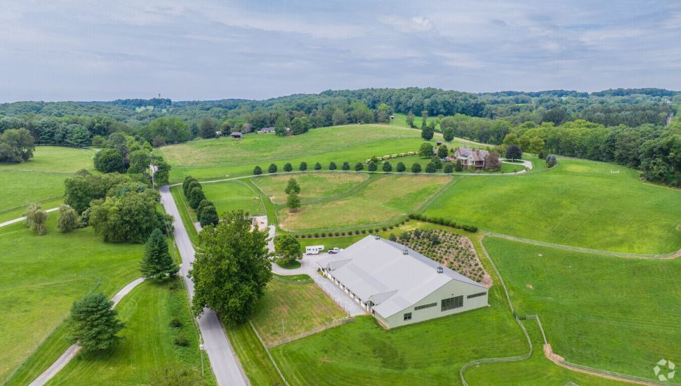 Green hills with gray blue sky and farms.