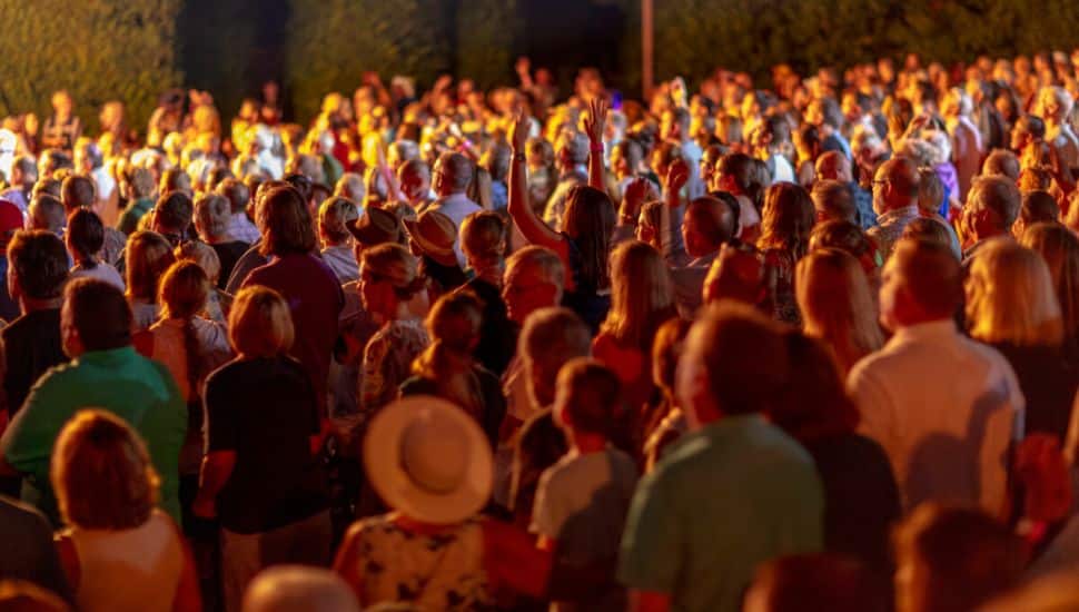Audience listening to music performance at night at Longwood Gardens.